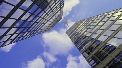 A jet plane flying over the top of two big city downtown skyscraper office buildings in a 3D illustration.