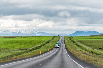 Fototapeta na wymiar Mountains view in Hveragerdi, Iceland with road trip car and truck on ring road on cloudy day and south golden circle route, Toyota dealer