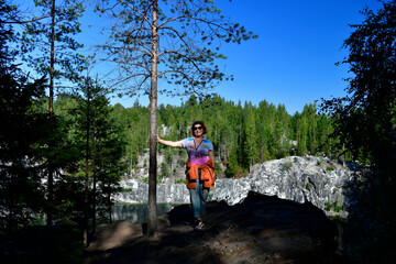 Fototapeta na wymiar woman tourist on the background of the mountain northern waterfall