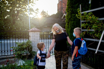 Little boys seeing their grandmother after long time in quarantine