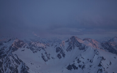 Fototapeta na wymiar Sunset in mountains. Snowy peaks.