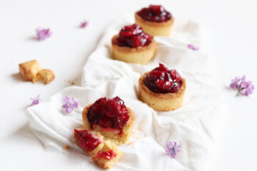 Tartlets with cherry on white background.