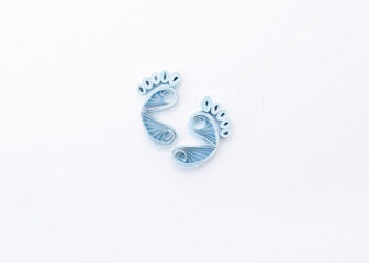 Cute baby boys footprints. Traces of children on white background. Baby footsteps. Hand made of paper quilling technique.
