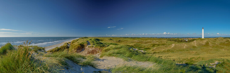 Panoramic view of Lyngvig lighthouse on wide dune of Holmsland Klit with beach view on the west coast of Jutland, by Hvide Sande, Denmark