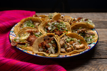 Assortment of mexican tacos on wooden background