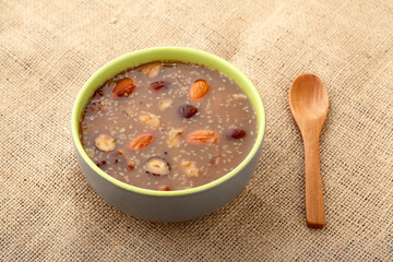 A bowl of ashura (noah's pudding) and wooden spoon