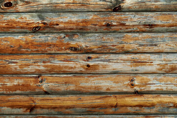 old weathered wooden planks as a brown background, peeling paint and cracks