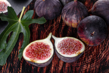 Fresh ripe figs on a dark concrete background. Harvesting figs