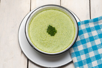 Cream of broccoli soup on white background