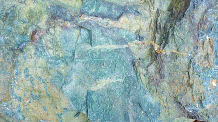 Stone texture of blue-green jasper. Turquoise background with stone texture. Design template with gabbro diabase background and space for text.