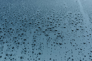 Texture of raindrops on the blue glass.