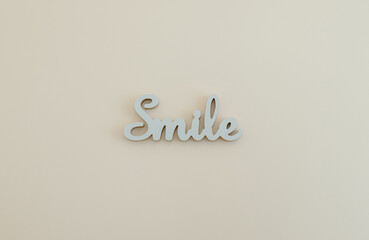 A wood letters smile on the wall.