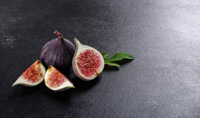 Fresh ripe figs on a dark concrete background. Harvesting figs