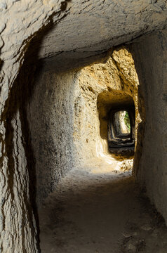Tunnel hollowed out in a rock over the gorge of the Aniene river next to the Villa of Manlio Vopisco. Tivoli, Italy