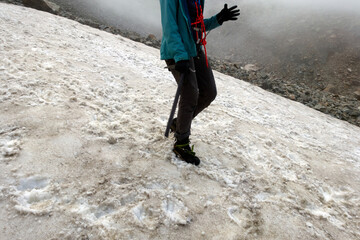 Climber at the training camp. Climber train to walk in crampons on the glacier. Caucasus.