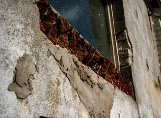 windows in broken brick wall