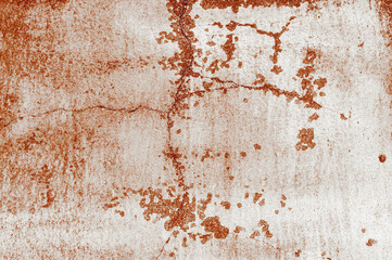 Texture of old red painted building wall with cracks and smudges close up