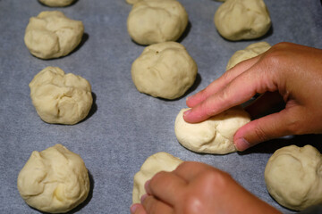 woman hands kneading buns