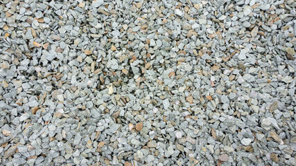 Natural stone crumb. Stone background from natural stone chips: jasper, serpentine, granite. Stone chips for landscaping, garden paths, flower arrangement. Texture of small stones with sharp edges.