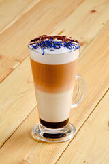 Latte macchiato with chocolate and dry knapweed petals