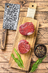 Raw fresh marbled meat Steak fillet mignon. Wooden background. Top view