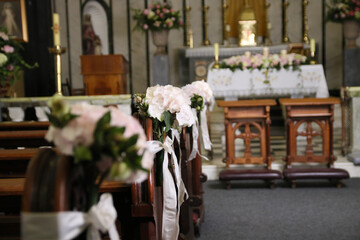 Interior of a catholic church, beautifully decorated with flowers for a wedding ceremony.