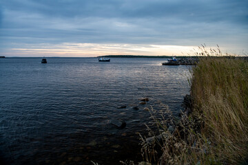beautiful landscape with old wooden port, stones and sea at sunrise