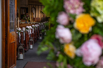 Interior of a catholic church, beautifully decorated with flowers for a wedding ceremony.