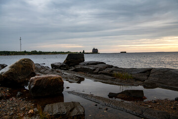 beautiful landscape with old wooden port, stones and sea at sunrise