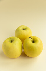 yellow golden delicious apples on yellow background