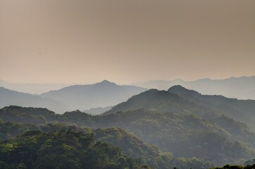 Mountain tops in misty sunset