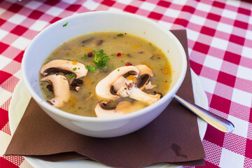 Creme soup with mushrooms in white bowl