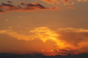 Fiery orange sunset sky. Beautiful colors and clouds.