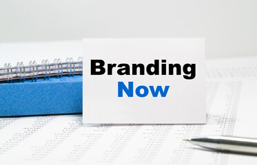Branding Now text on white card, amid financial statements