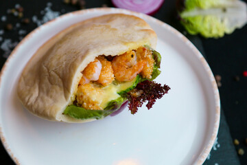 Mexican food. Homemade tacos with shrimp, avocado and salsa sauce on a dark rustic background. Overhead.
