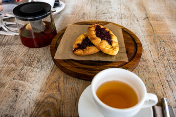 breakfast with tea and pies on a brown table