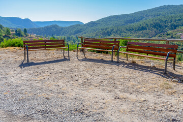Fototapeta na wymiar Wooden benches set on the side of a mountain to provide wonderful views