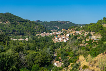 Fototapeta na wymiar View of a beautiful rural town located on the side of a mountain surrounded by a lot of very green vegetation