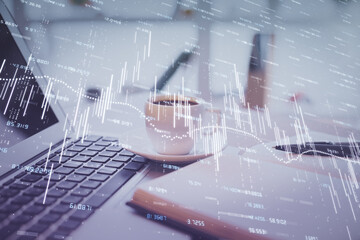 Double exposure of financial chart drawing and desktop with coffee and items on table background. Concept of forex market trading