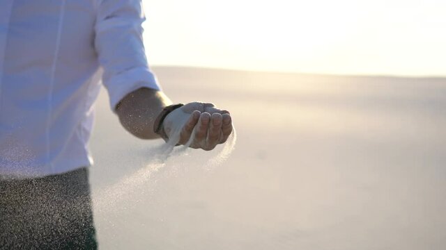  sand is falling from the hands of a businessman. High quality FullHD footage