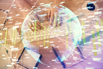 Double exposure of man's hands typing over computer keyboard and business theme hologram drawing. Top view. Financial markets concept.