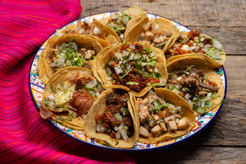 Assortment of mexican tacos on wooden background