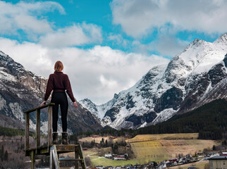 Fototapeta na wymiar Norway - Girl by Farm and mountain view in Møre og Romsdal 