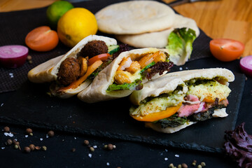 three Pita salad with roasted chicken and vegetables, served with a delicious sauce