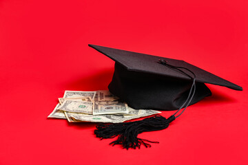 Graduation hat and money on color background. Tuition fees concept
