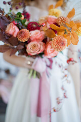 Bride with colorful autumn bouquet
