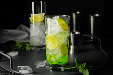 Glass of fresh mojito on table