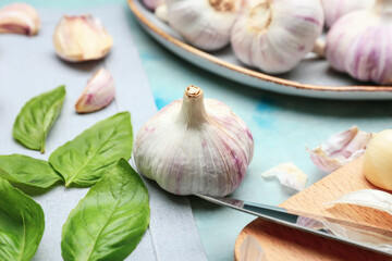 Fresh garlic and basil on table