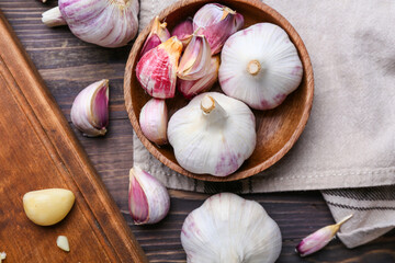 Composition with fresh garlic on wooden background