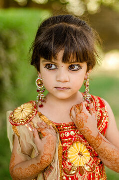A girl child showing her Henna adorned arms